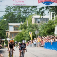 Two women riding through the finish line at the racethe-2013-Parx-Casino-Philly-Cycling-Classic