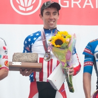Eric Young smiles on the podium
